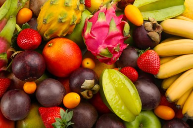 Assortment of fresh exotic fruits as background, top view