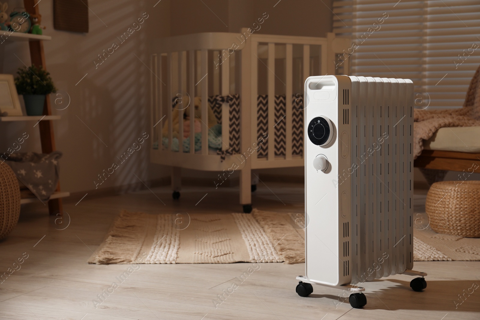 Photo of Modern portable electric heater in child room, space for text