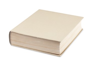 Photo of One closed beige hardcover book isolated on white