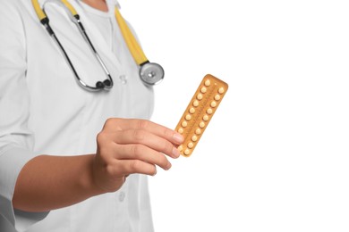 Doctor holding blister of oral contraception pills on white background, closeup