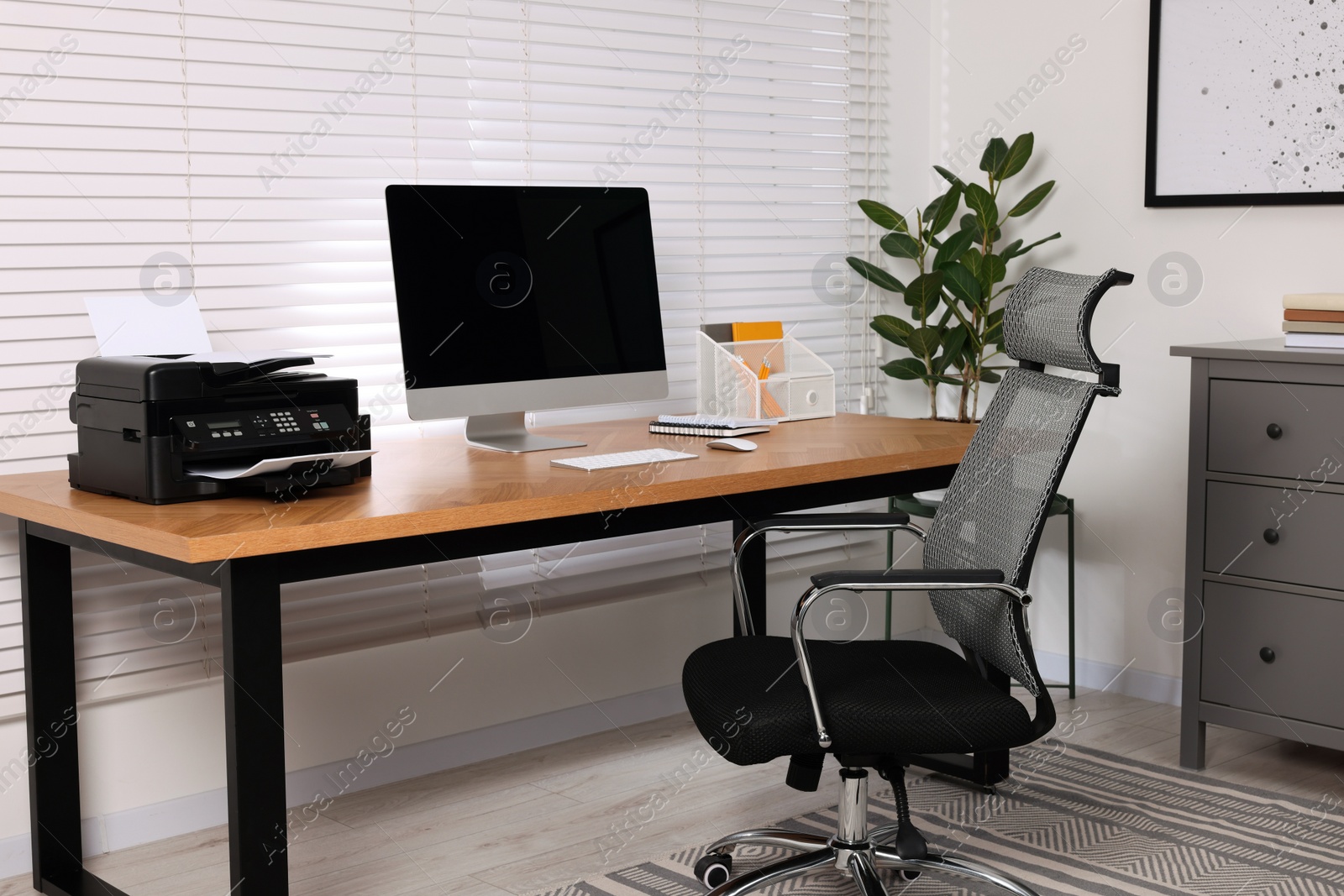 Photo of Stylish room interior with desk, modern printer and computer