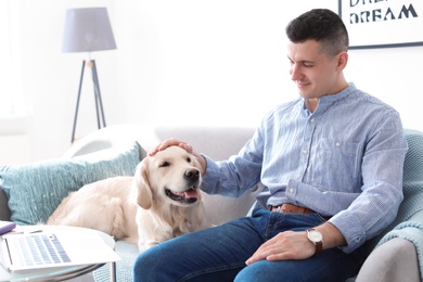 Photo of Portrait of owner with his friendly dog at home