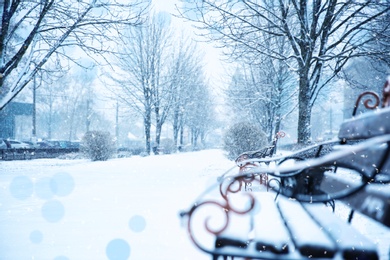 Snowflakes falling in city park, bokeh effect