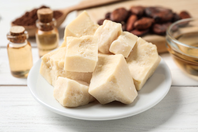 Organic cocoa butter on wooden table, closeup