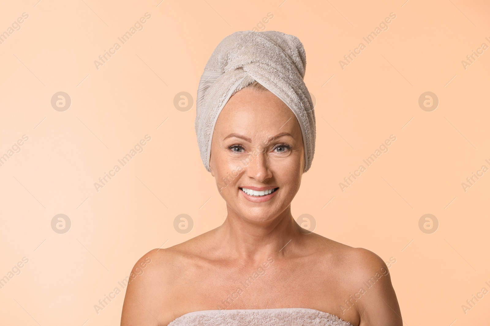 Photo of Portrait of beautiful mature woman with perfect skin on beige background