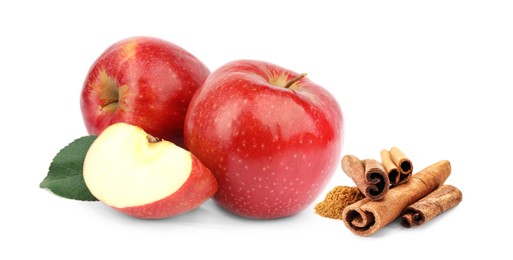 Aromatic cinnamon sticks, powder and red apples isolated on white