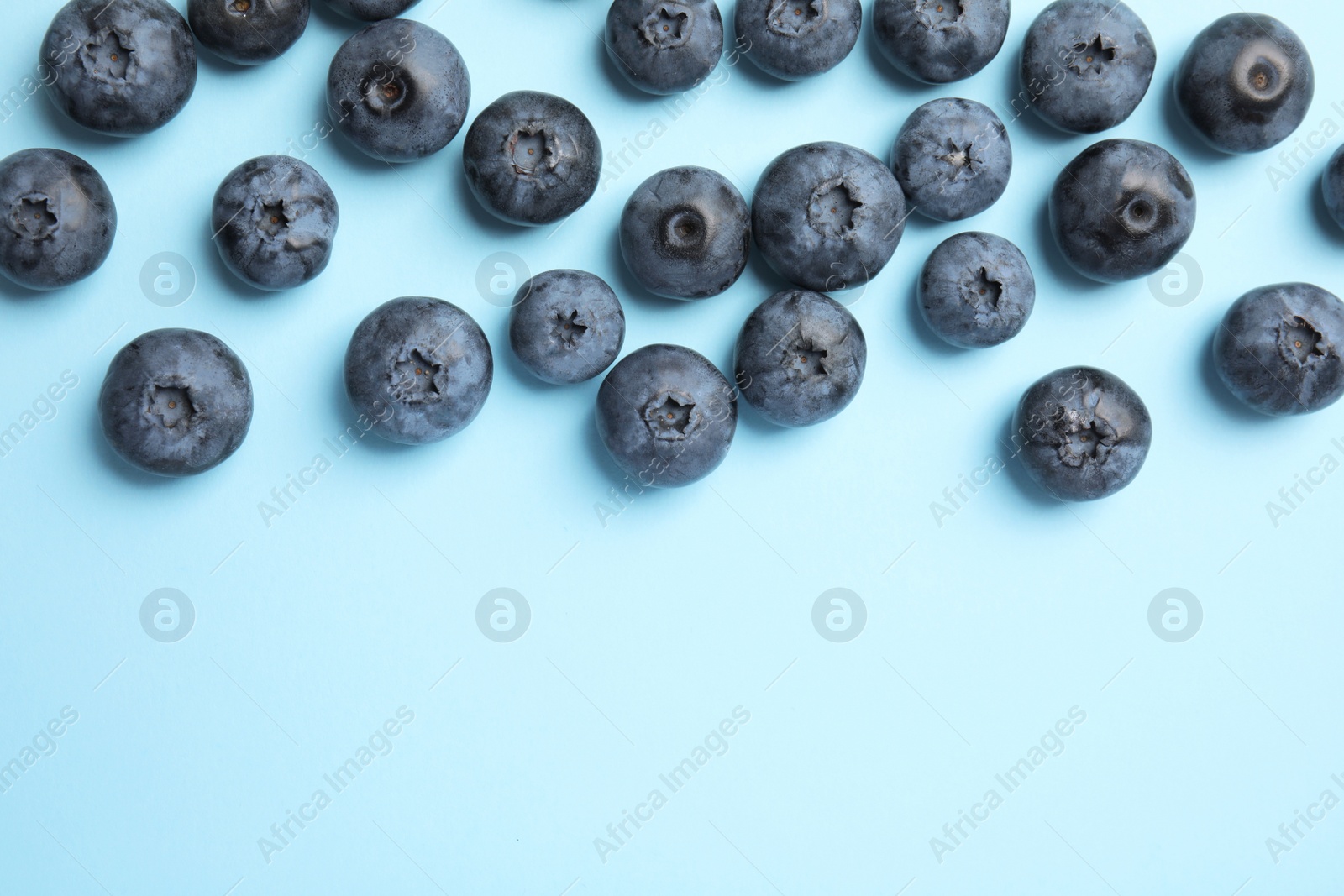 Photo of Flat lay composition with tasty blueberry and space for text on color background