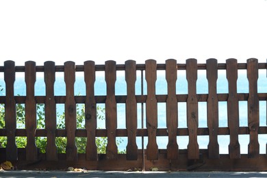 Wooden fence against sky on sunny day outdoors