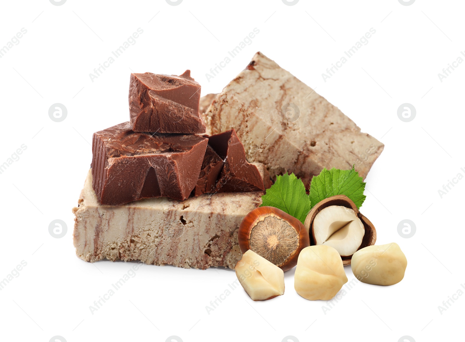 Image of Tasty halva, pieces of chocolate, hazelnuts and green leaves isolated on white