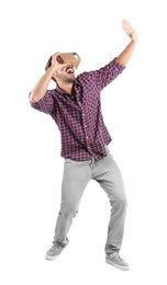 Photo of Young man using cardboard virtual reality headset, isolated on white