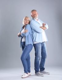Photo of Upset mature couple on grey background. Relationship problems
