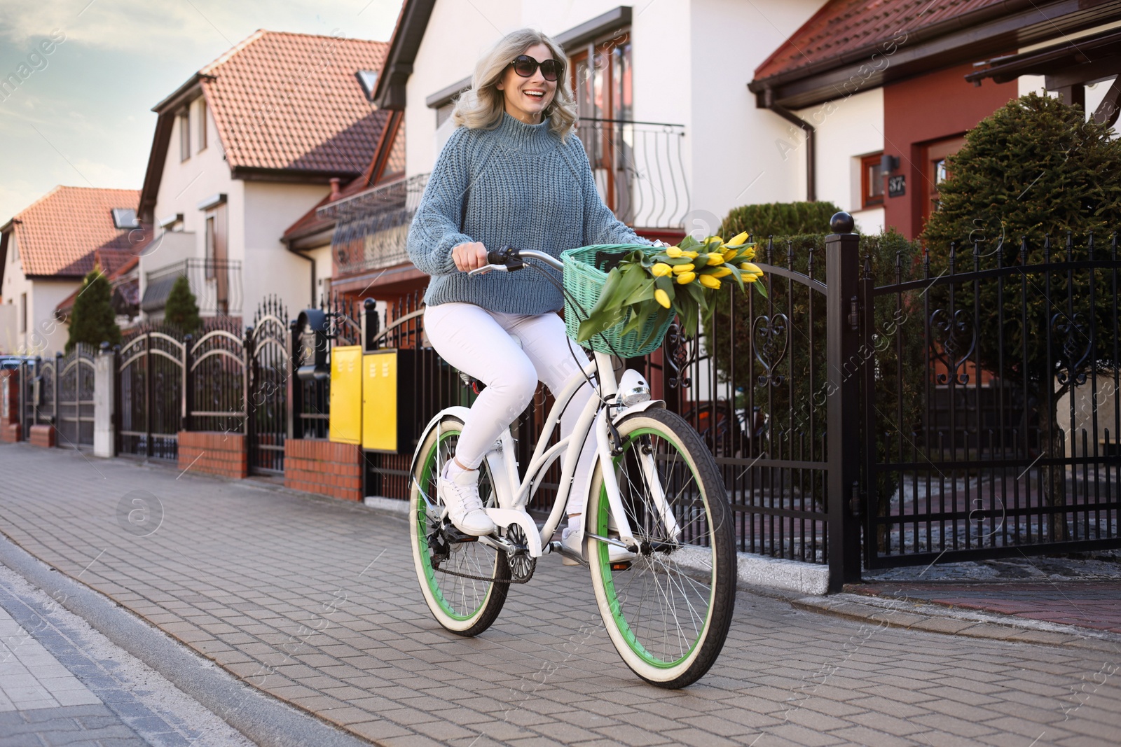 Photo of Beautiful woman riding bicycle on city street