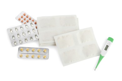 Photo of Mustard plasters, pills and thermometer on white background, top view