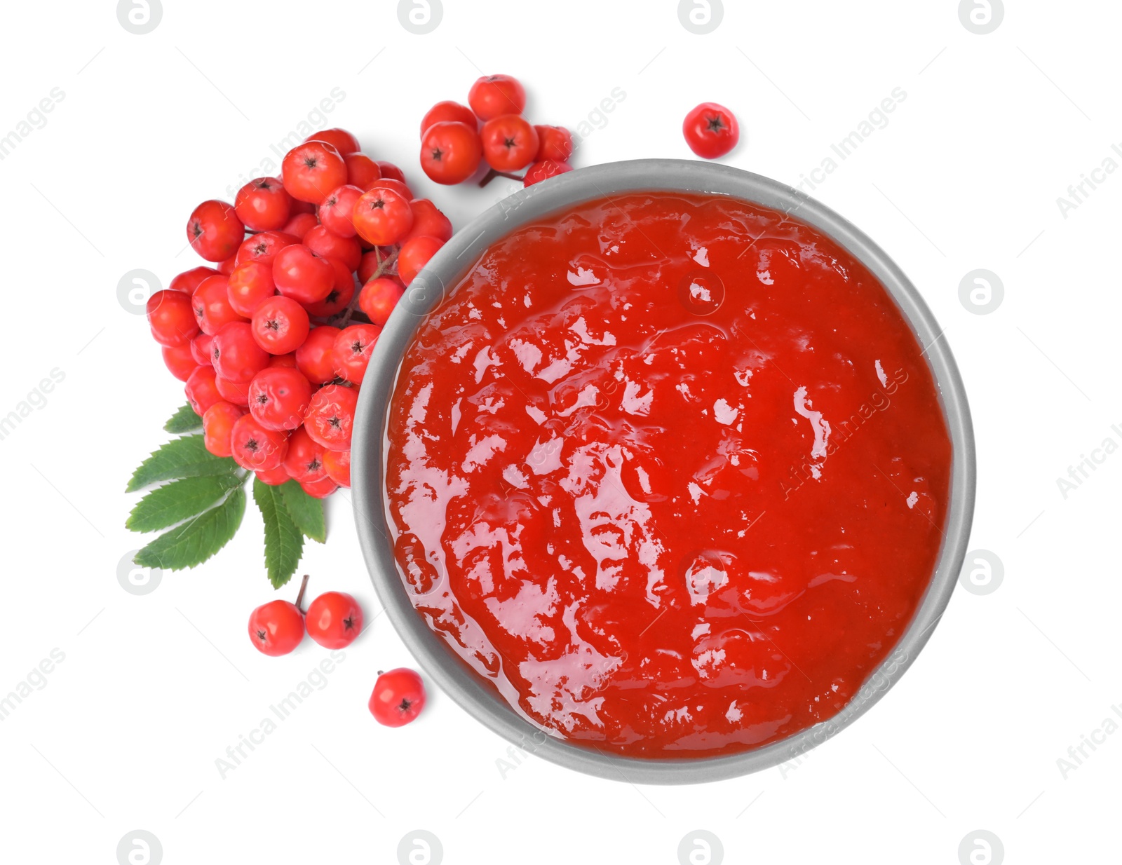 Photo of Delicious rowan jam in bowl and berries on white background, top view