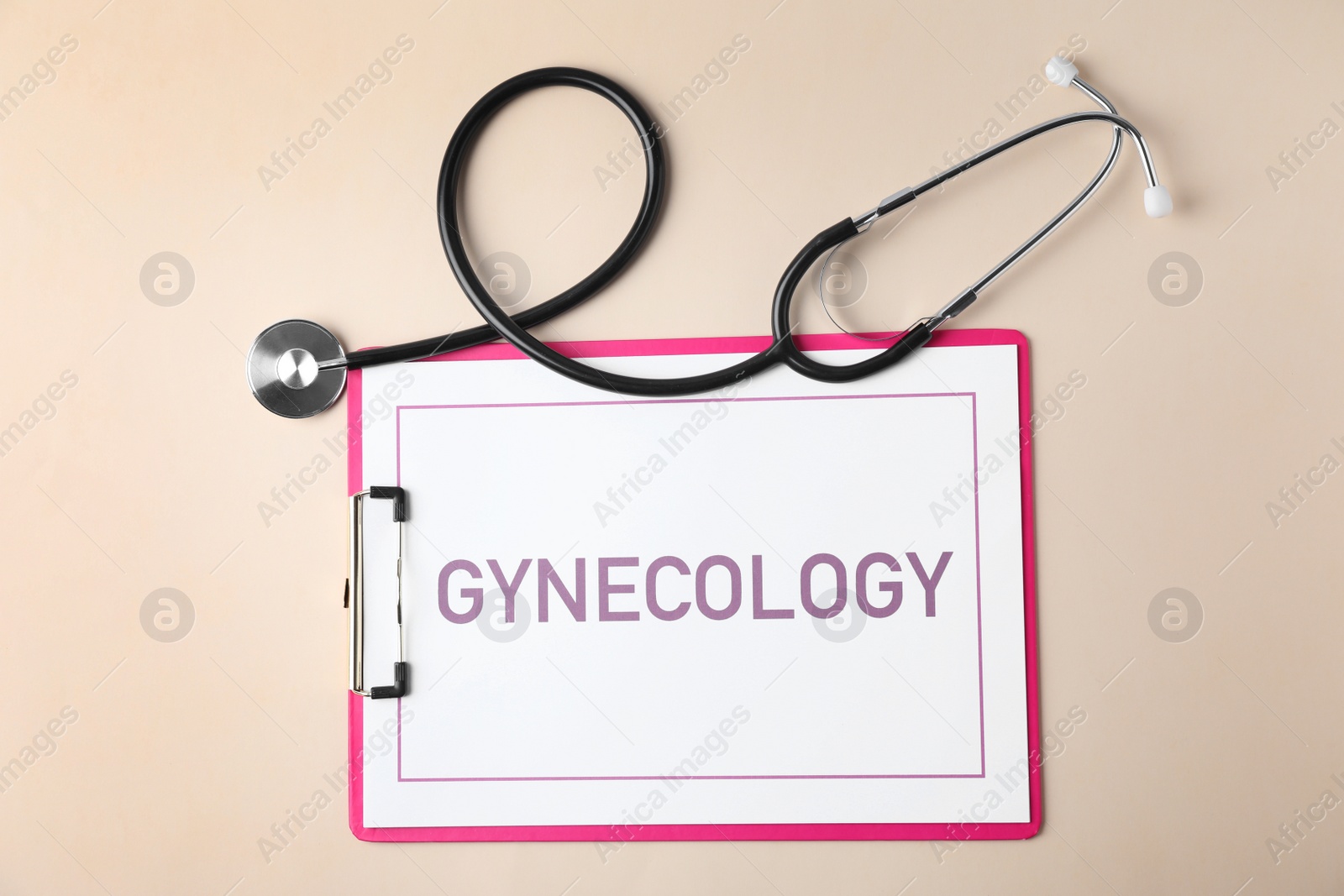 Photo of Clipboard with word Gynecology and stethoscope on color background, flat lay