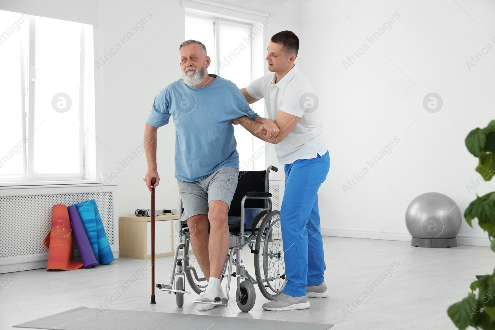 Photo of Professional physiotherapist working with senior patient in rehabilitation center