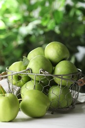 Ripe green apples on white table outdoors