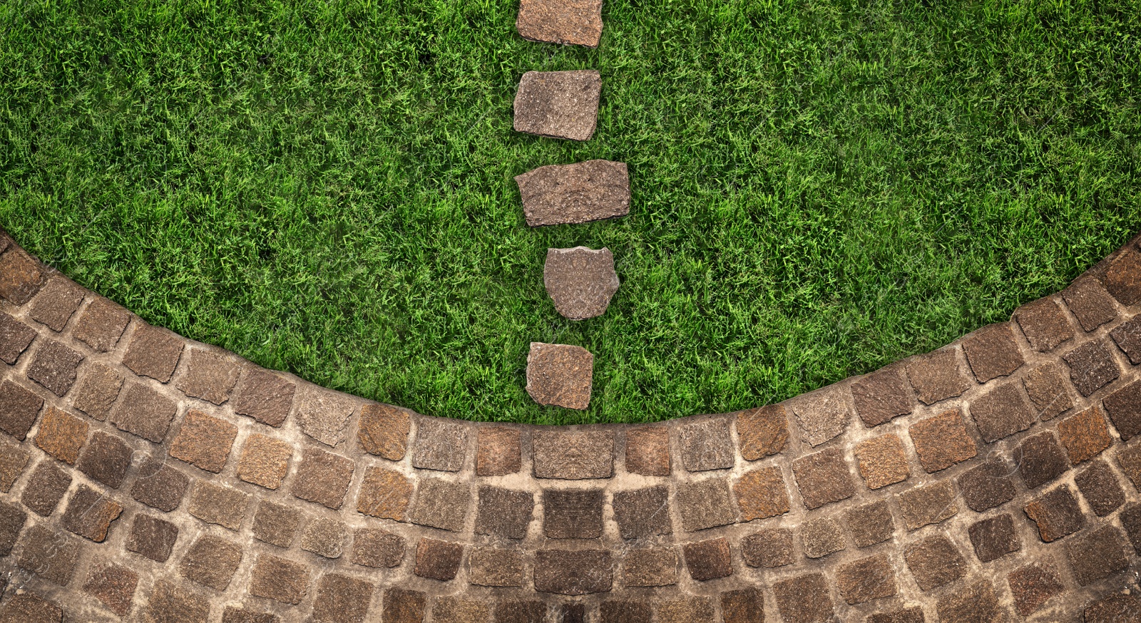 Image of Fresh green grass and stone tiles outdoors, top view. Banner design