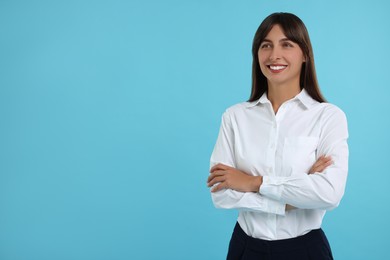 Photo of Portrait of happy secretary on light blue background. Space for text