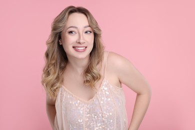 Photo of Portrait of smiling woman on pink background