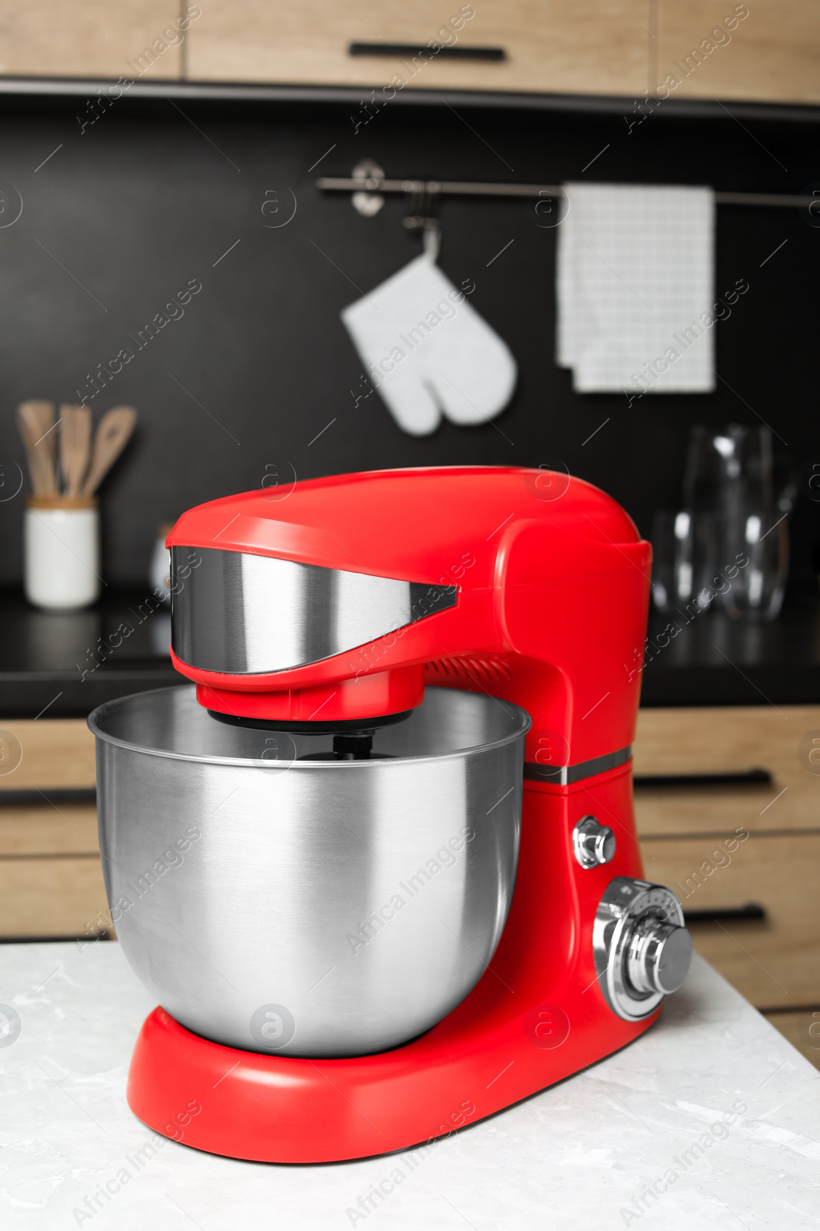 Photo of Modern stand mixer on table in kitchen. Home appliance