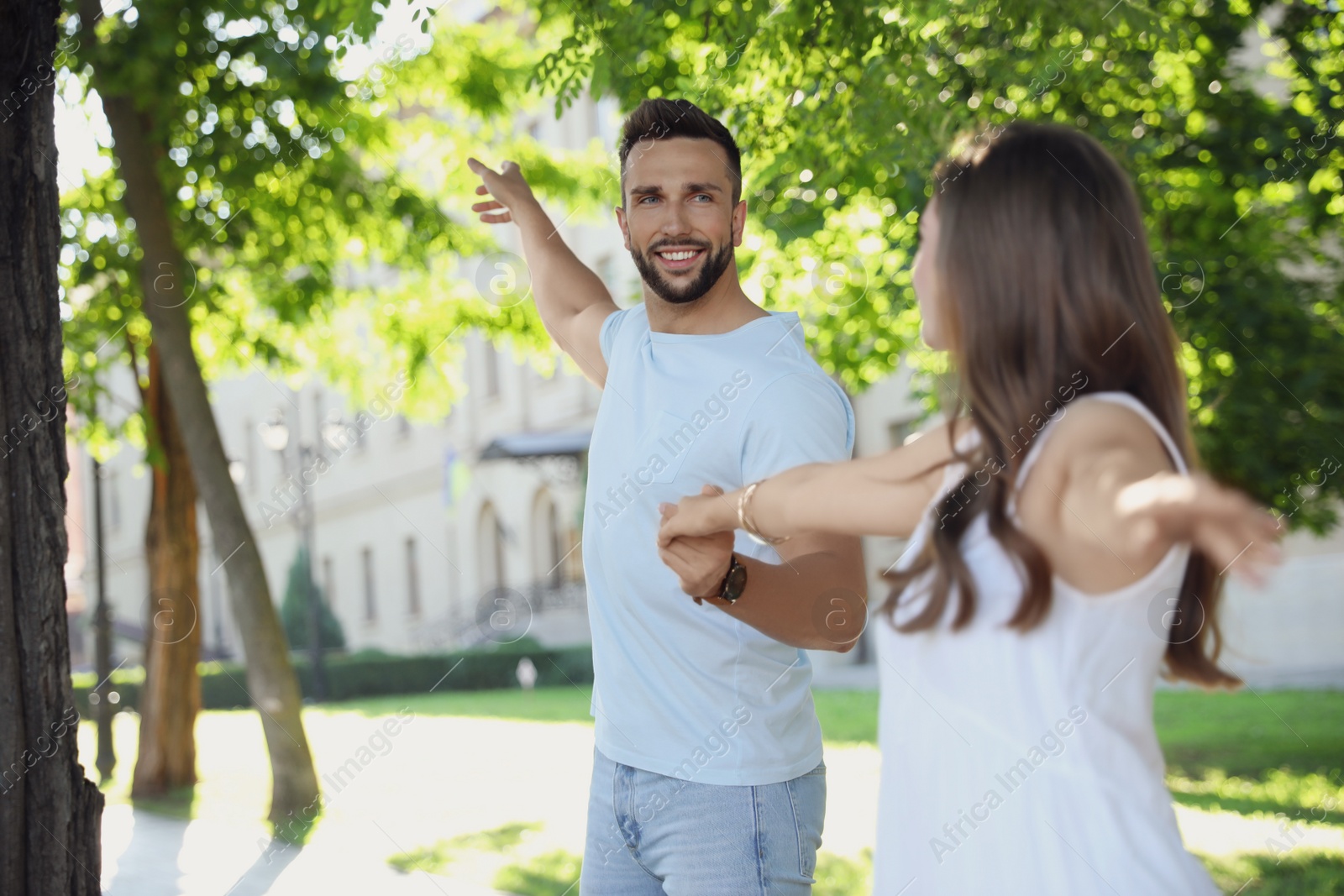 Photo of Lovely young couple dancing together in park on sunny day