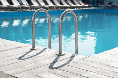 Photo of Modern swimming pool with ladder at resort