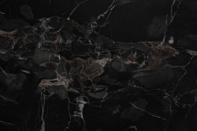 Black marble surface as background, closeup view