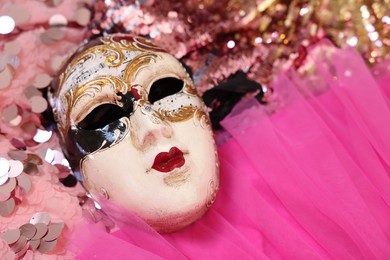 Photo of Carnival mask and beautiful pink costume with sequins, above view