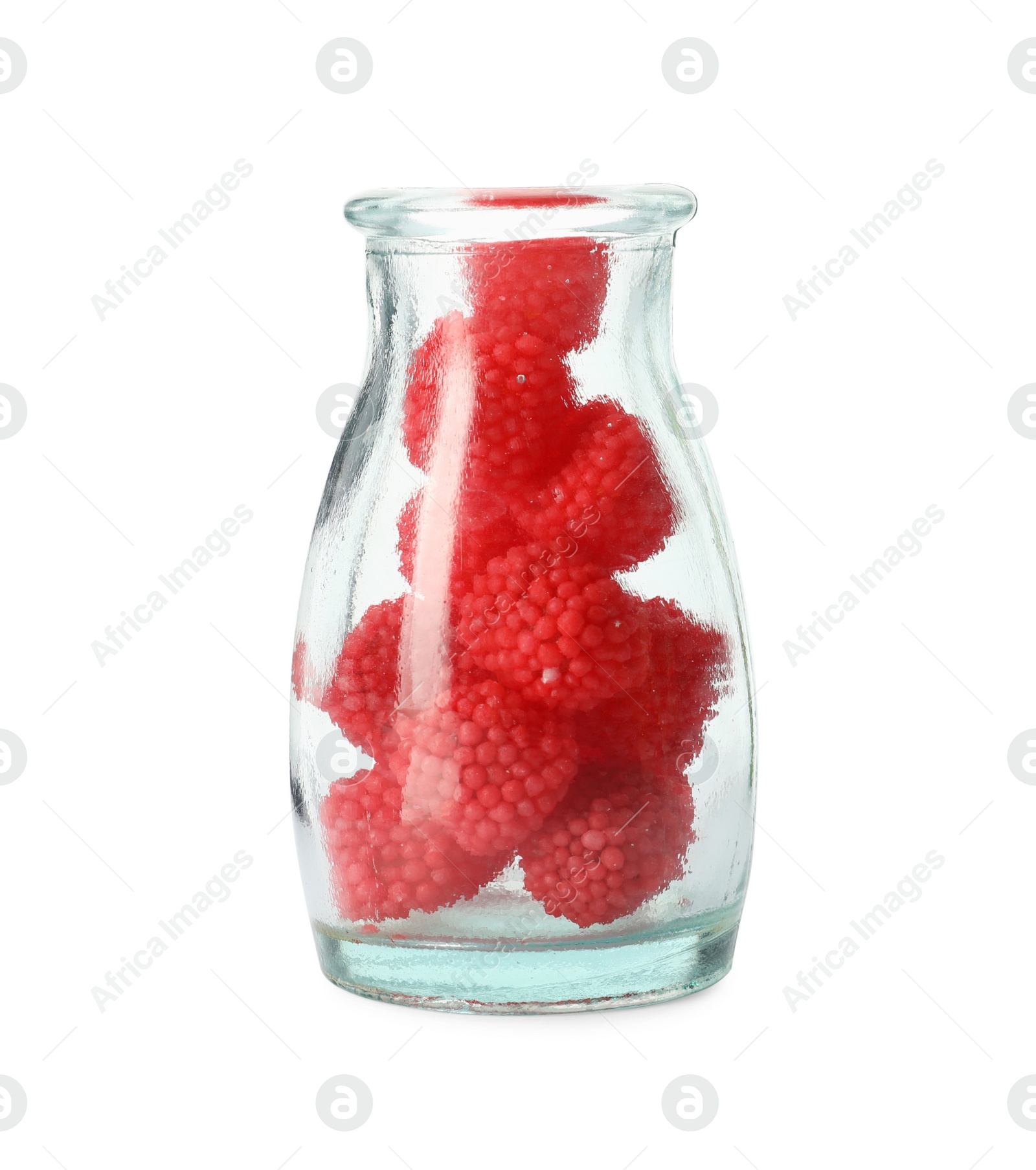 Photo of Delicious gummy raspberry candies in glass bottle on white background