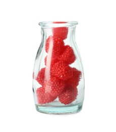 Photo of Delicious gummy raspberry candies in glass bottle on white background