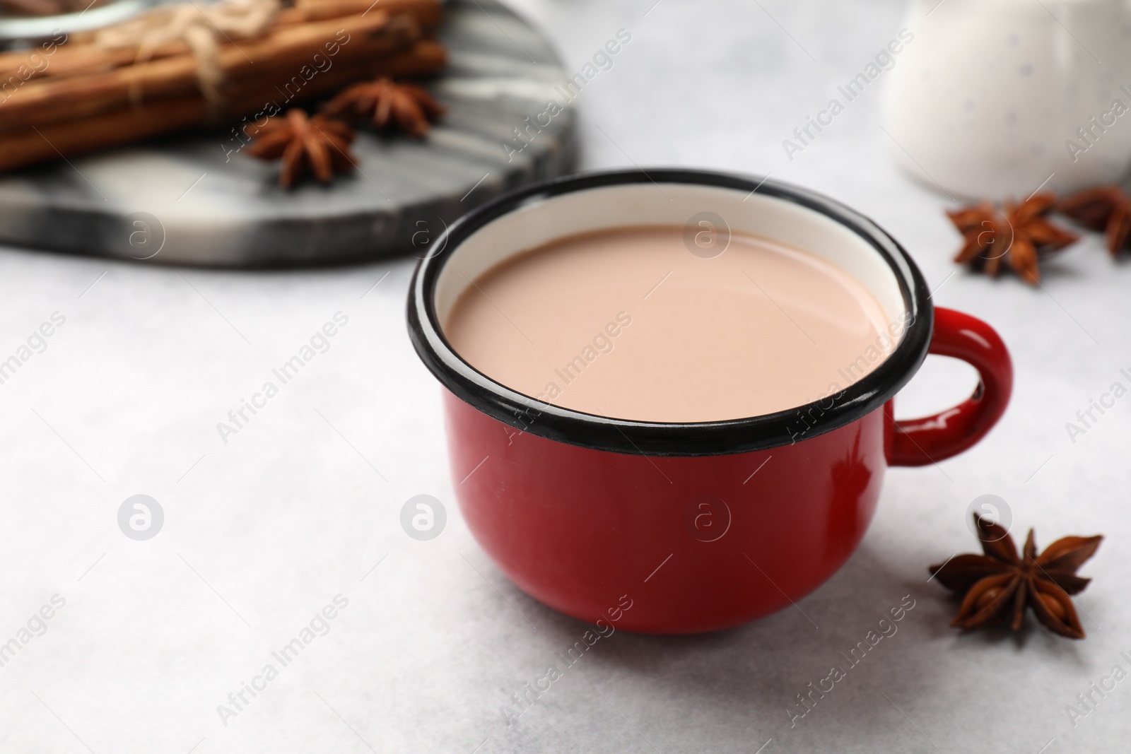 Photo of Tasty hot chocolate in cup on light table, closeup. Space for text