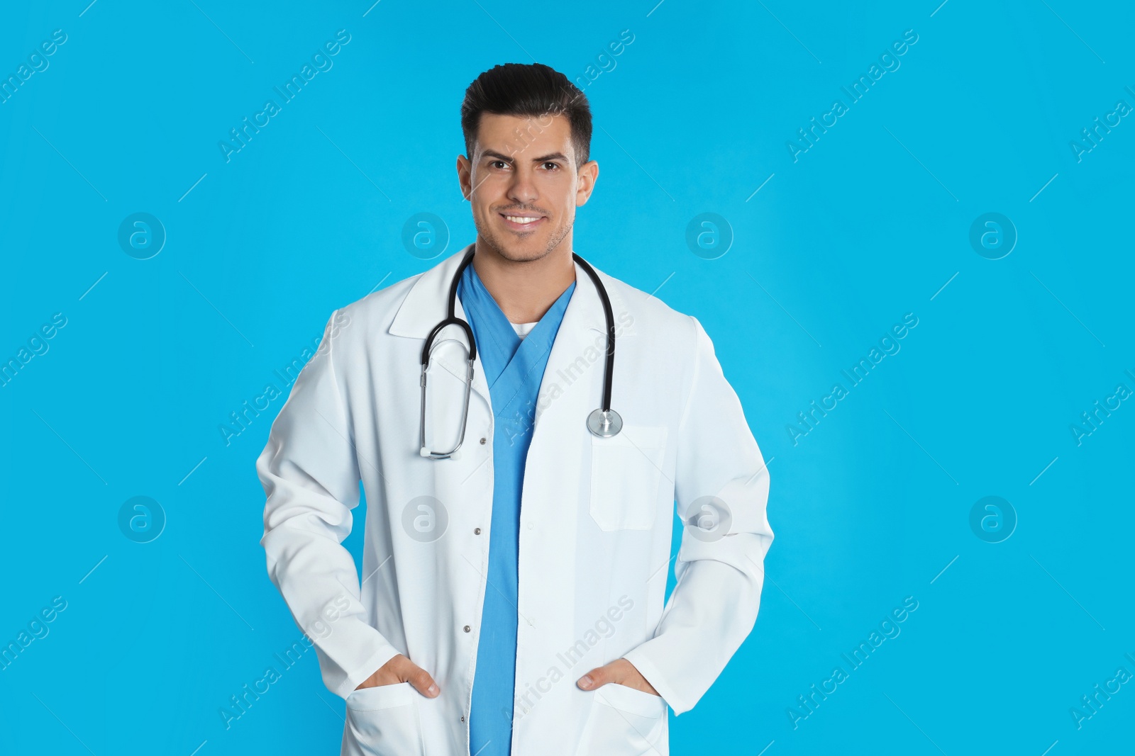 Photo of Portrait of doctor with stethoscope on blue background