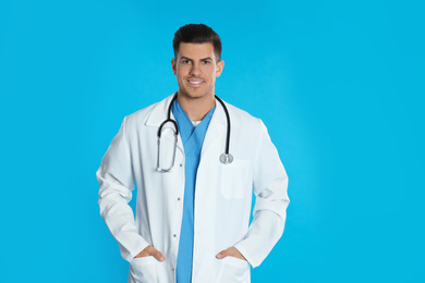 Photo of Portrait of doctor with stethoscope on blue background