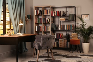 Photo of Cozy home library interior with collection of different books on shelves