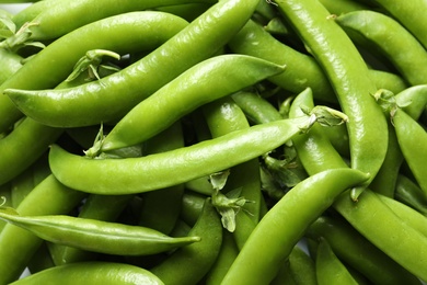 Photo of Many fresh green peas as background, top view