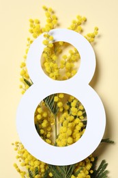 Photo of 8 March greeting card design with mimosa flowers on beige background, top view. Happy International Women's Day