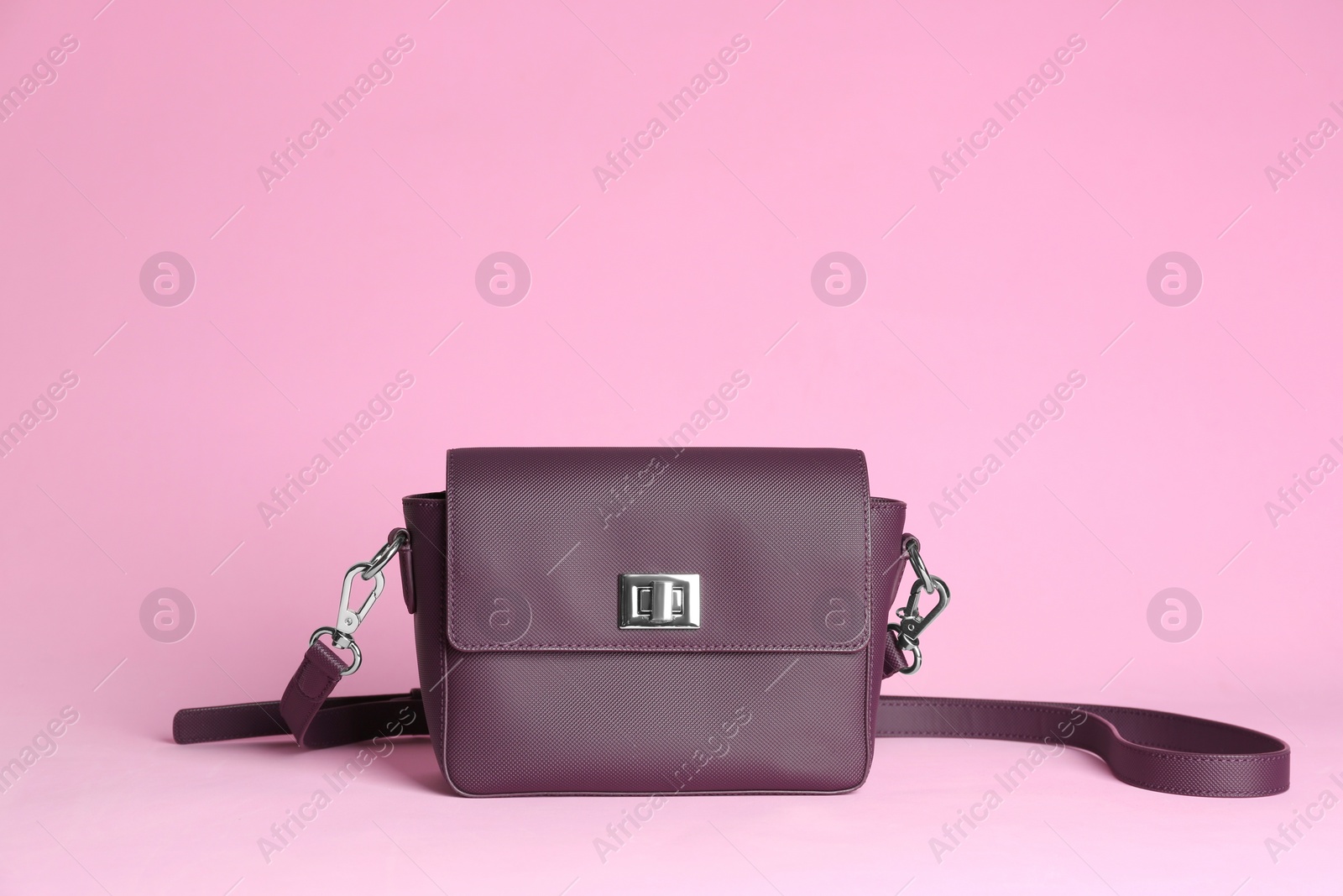 Photo of Stylish woman's bag on light pink background