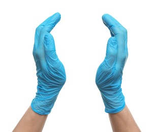 Doctor wearing light blue medical gloves holding something on white background, closeup