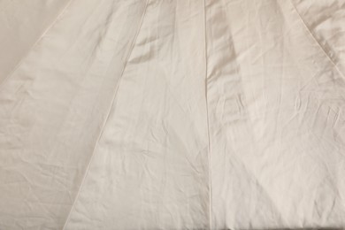 Crumpled beige fabric as background, closeup view