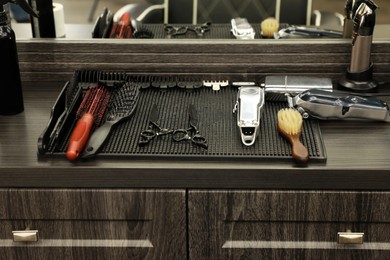 Photo of Stylish hairdresser's workplace with professional tools in barbershop
