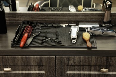 Stylish hairdresser's workplace with professional tools in barbershop