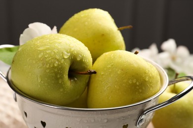 Photo of Colander with fresh wet apples on table, closeup