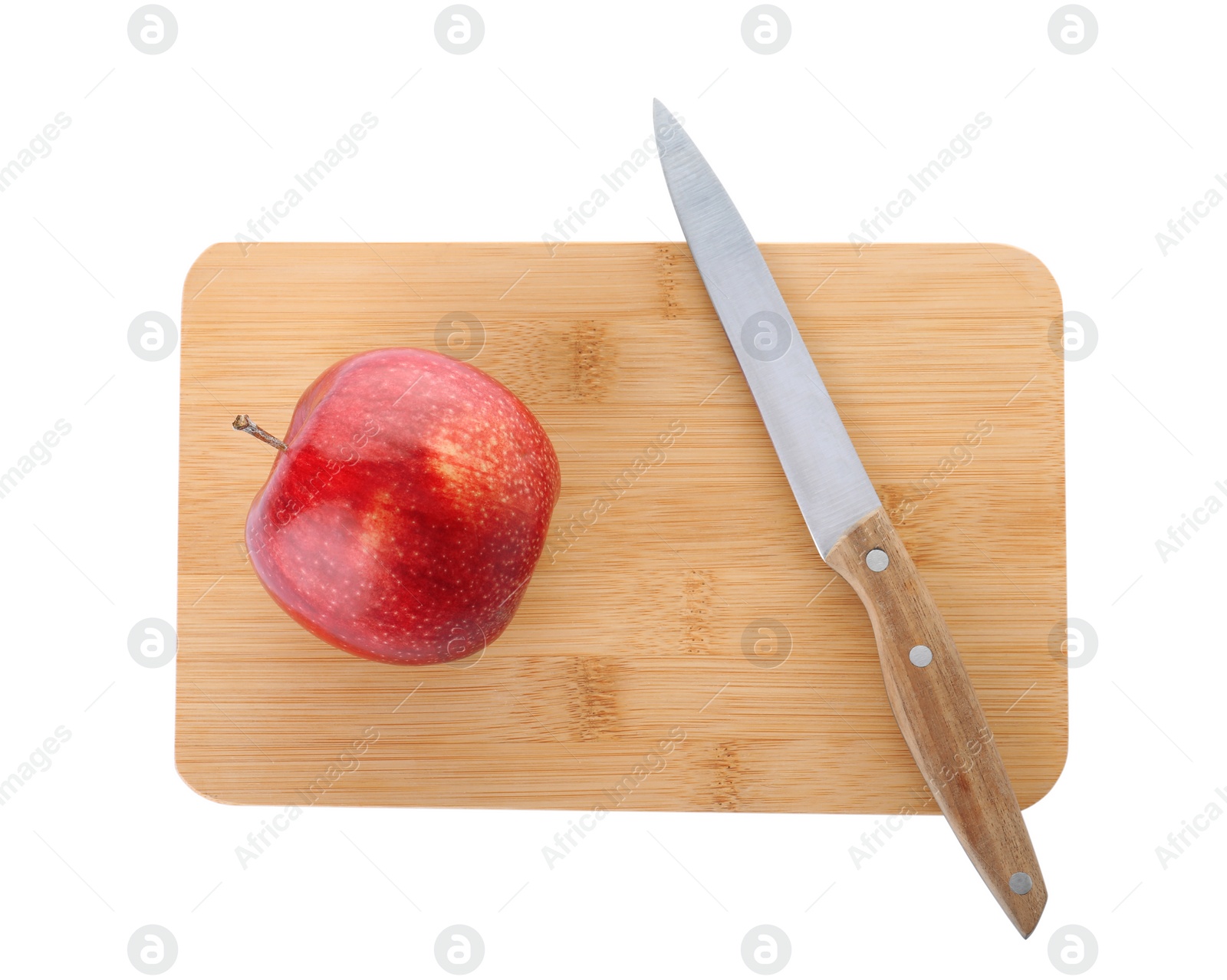 Photo of Wooden cutting board with apple and utility knife isolated on white, top view