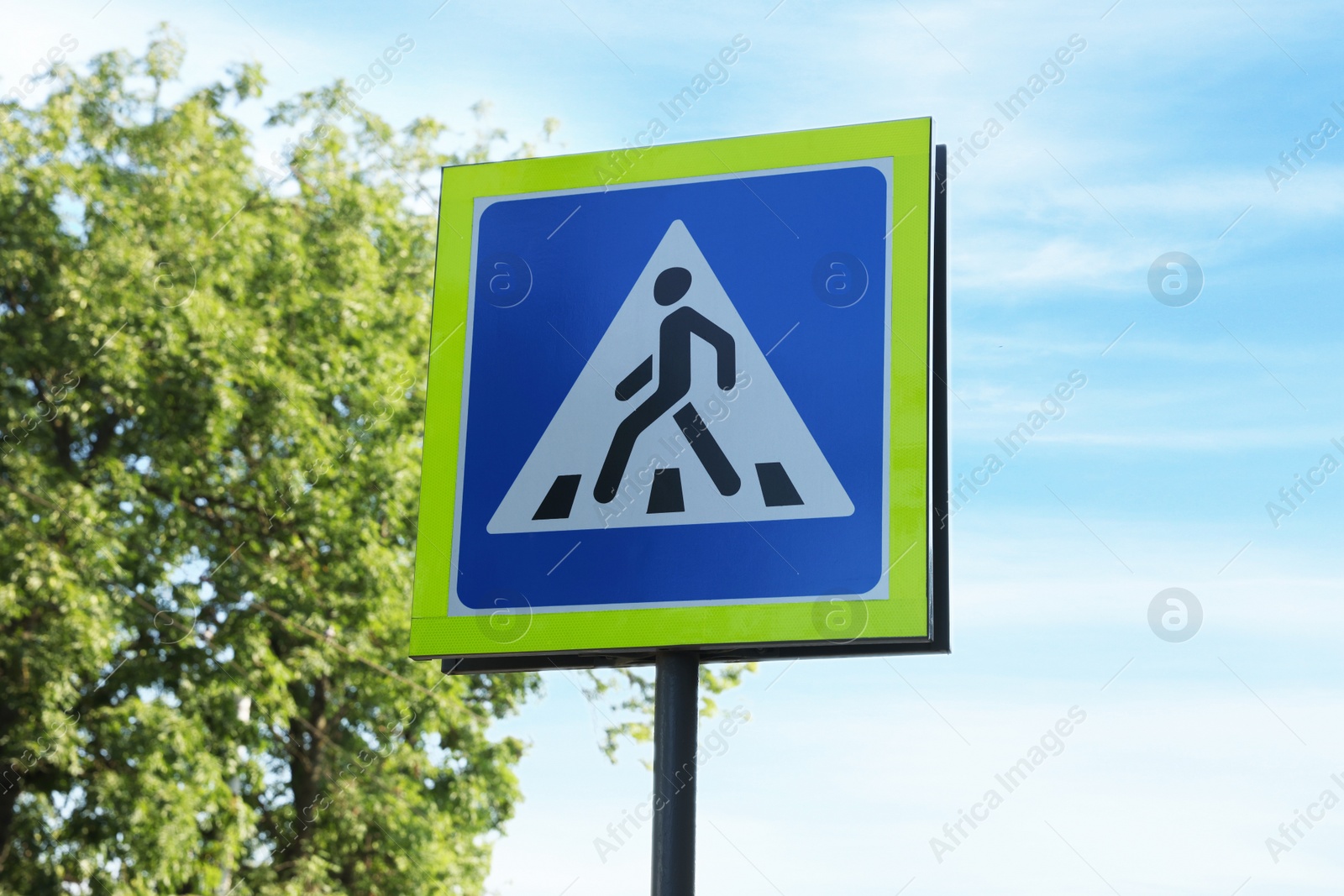 Photo of traffic sign Pedestrian Crossing against blue sky