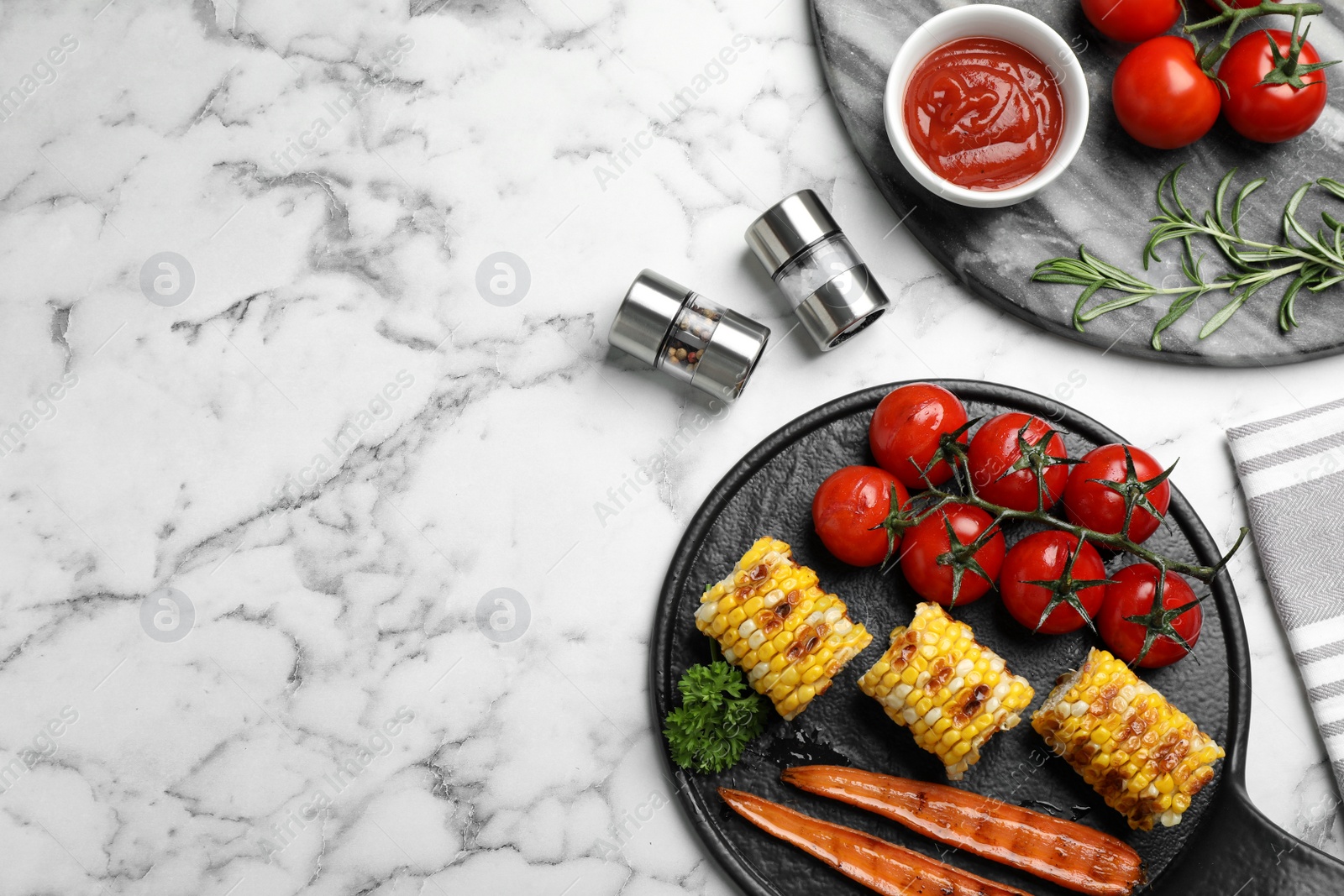 Photo of Delicious grilled vegetables served on white marble table, flat lay. Space for text