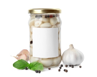 Photo of Composition with jar of pickled garlic on white background