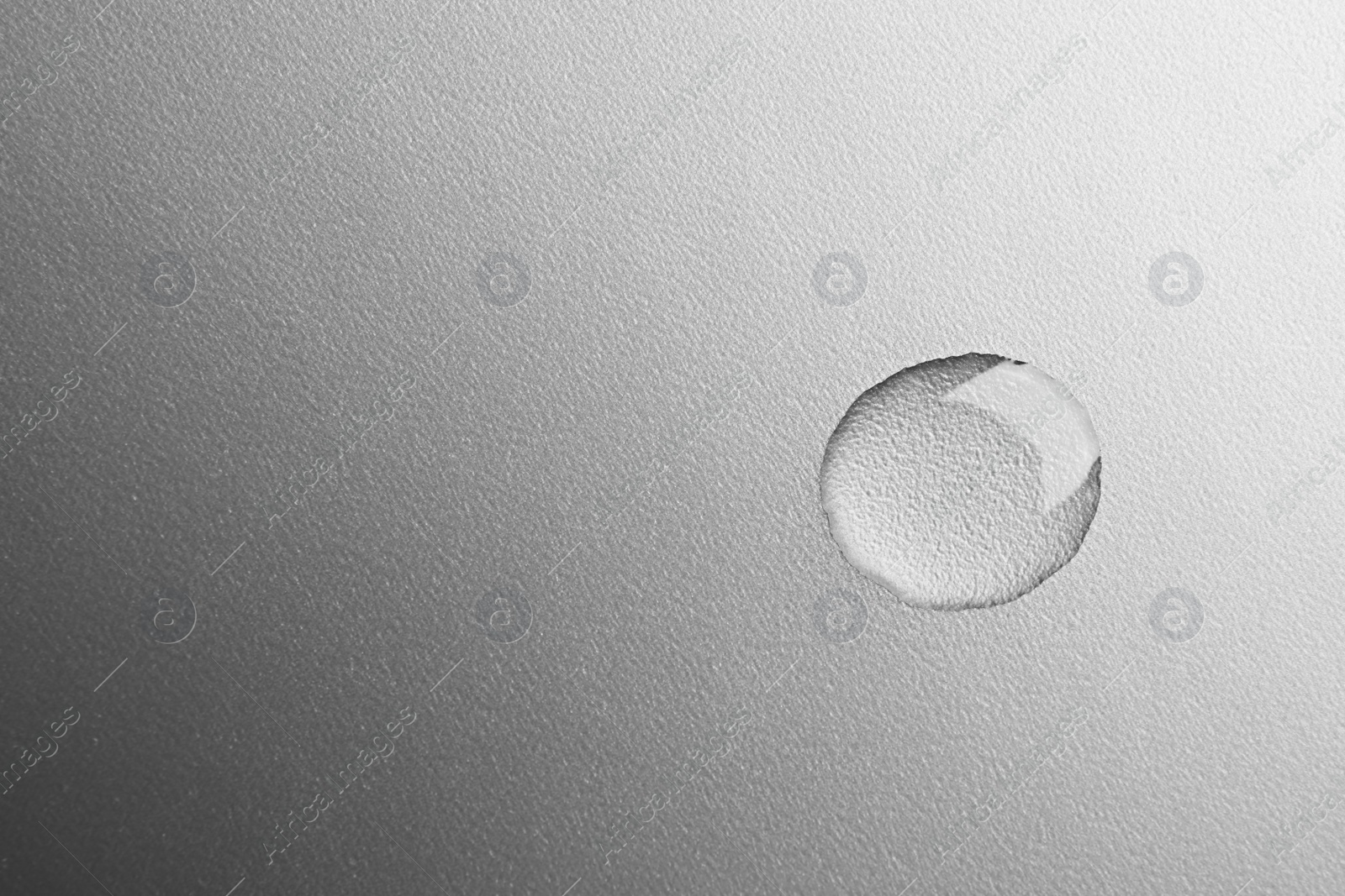 Photo of Beautiful clean water drop on grey background