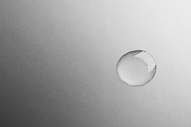 Photo of Beautiful clean water drop on grey background