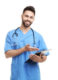 Photo of Young male doctor in uniform with clipboard isolated on white